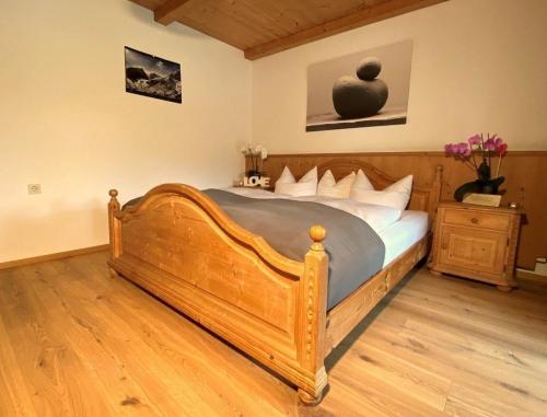 a bedroom with a large wooden bed in a room at Tolle Ferienwohnung in Vorderthiersee mit Grill, Garten und Terrasse in Thiersee
