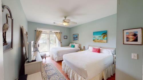 a bedroom with two beds and a window at Litchfield Lakeside Oasis 2BR Villa near the Beach in Pawleys Island