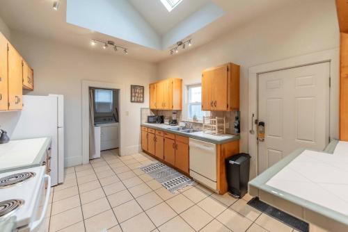 a kitchen with wooden cabinets and a white refrigerator at New Gathering Place on Columbus in Waco