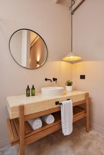 a bathroom with a sink and a mirror at Antipoda Hotel Boutique in Medellín
