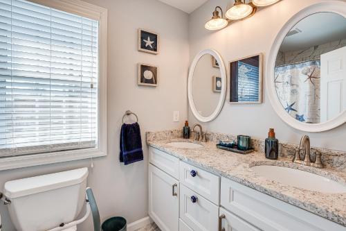 a bathroom with two sinks and a mirror at Long Branch Beach House with Private Hot Tub! in Long Branch