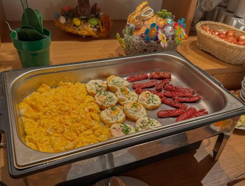 a tray of food with sausage and scrambled eggs at Penzion Čítkův Mlýn in Šluknov