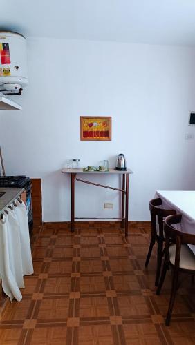 a kitchen with a table and a table and chairs at Dunas Doradas II in Tinogasta