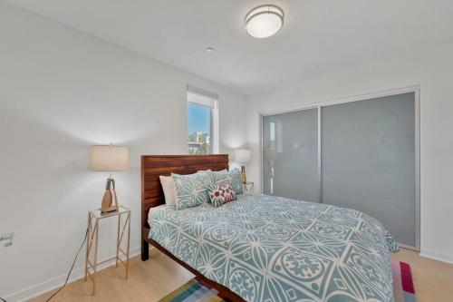 a bedroom with a bed and a lamp and a window at 3 Lux large apartment heart of SM in Los Angeles