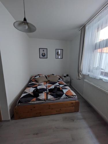 a bedroom with a bed in a room with a window at Penzion Grand Nymburk in Nymburk
