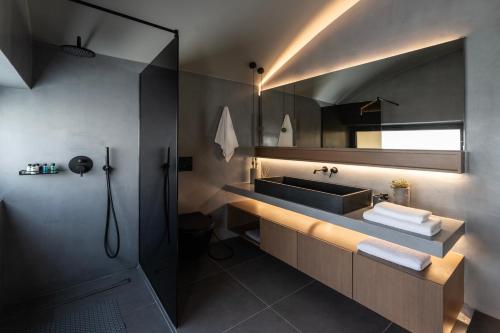 a bathroom with a sink and a mirror at The sand City apartment with Outdoor Hot Tub in Agios Nikolaos