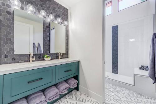 a bathroom with a blue vanity and a mirror at LaFave Luxury Rentals at Zion in Springdale