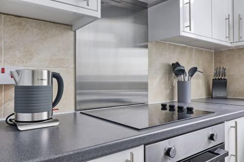 a kitchen with a coffee pot on a counter at High view house, 3 bed flat, Number 41A in Walton-on-the-Naze