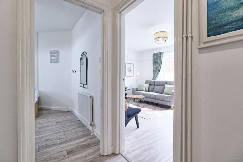 a hallway with a living room with a couch at High view house, 3 bed flat, Number 41A in Walton-on-the-Naze