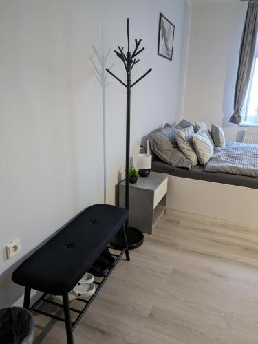 a room with a bed and a bench in it at Penzion Grand Nymburk in Nymburk