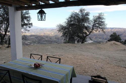 a table with a blue and white table cloth on top of a mountain at Finca "Ferienhaus" mit Schwimmbad in Bérchules