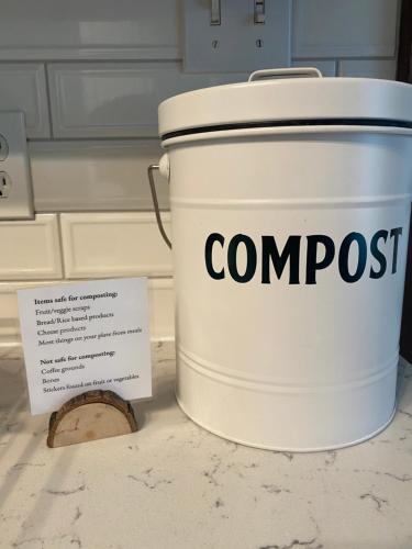 a bucket of compost sitting on a counter with a sign at Firefly Hills in Beattyville