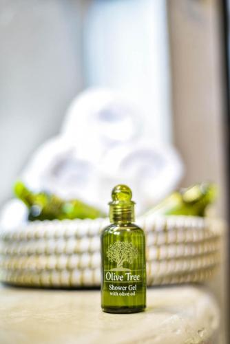 a bottle of olive tree smooth oil sitting on a table at DP Homes Santorini in Perissa