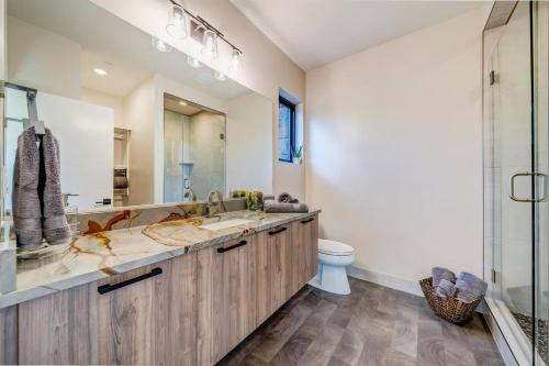 a bathroom with a double sink and a toilet at LaFave Luxury Rentals at Zion in Springdale