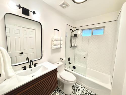 a bathroom with a sink and a toilet and a shower at NEW & Luxurious House, hot tub & amazing views in Lake Arrowhead