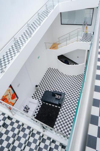 a spiral staircase with a black and white floor at Hotel Sky Blue in Manizales