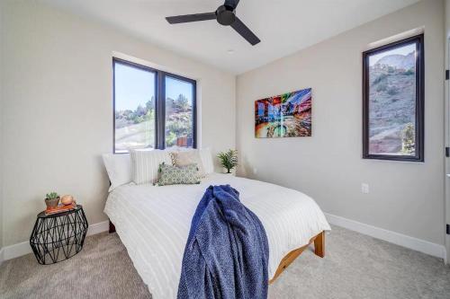 a bedroom with a bed with a ceiling fan at LaFave Luxury Rentals at Zion in Springdale