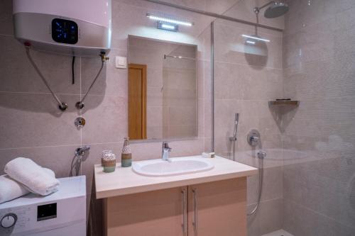 a bathroom with a sink and a shower at Budva Center Suite Old Town Sea Wiev 506 in Budva