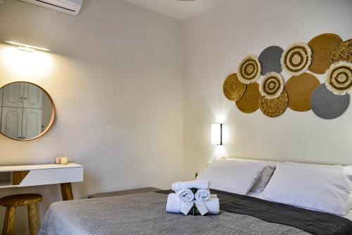 a bedroom with a bed with two towels on it at DP Homes Santorini in Perissa