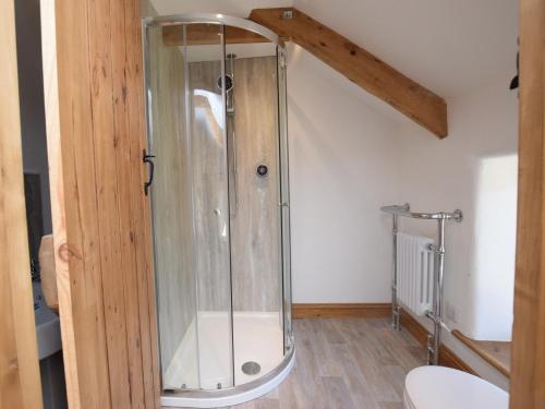 a shower stall in a bathroom with a toilet at 2 bed in Clovelly 56720 in Woolfardisworthy