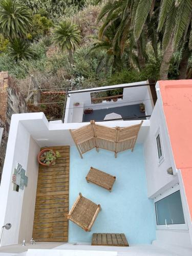 una vista aérea de una casa con sillas y un balcón en TheharmonyhouseTaganana en Taganana