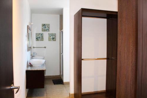 a bathroom with a toilet and a sink at The Luxury Apartment in San Salvador