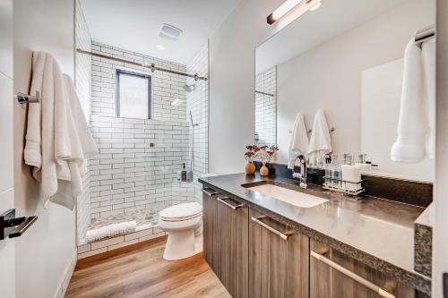 a white bathroom with a toilet and a sink at LaFave Luxury Rentals at Zion in Springdale