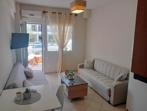 a living room with a couch and a table at Hara's house in Nei Poroi