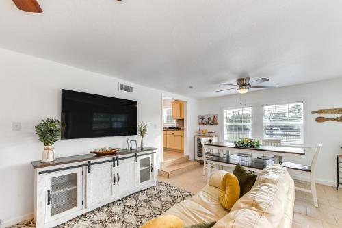 a living room with a couch and a flat screen tv at 1 Mi to Dtwn Waco! Lovely Home with Fire Pit Table in Waco