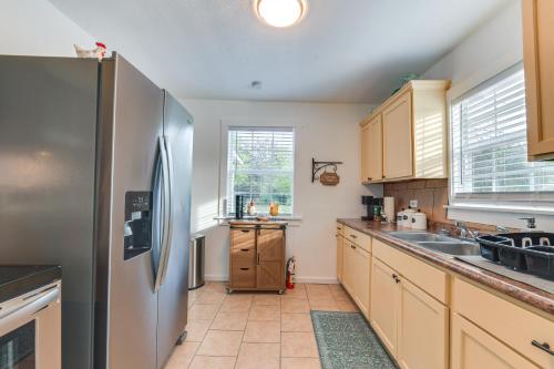 a kitchen with a stainless steel refrigerator at 1 Mi to Dtwn Waco! Lovely Home with Fire Pit Table in Waco
