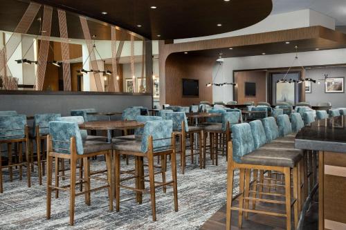 a restaurant with chairs and tables in a room at Embassy Suites Springfield in Springfield
