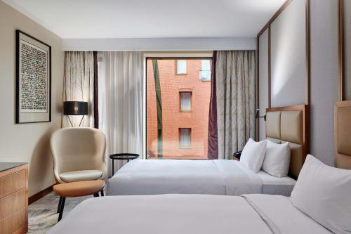 a hotel room with two beds and a window at Hilton Gdansk in Gdańsk