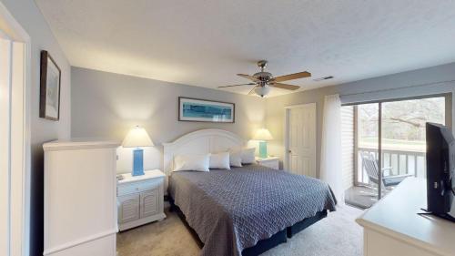 a bedroom with a bed and a ceiling fan at Two Bdrm Villa, True Blue, Golf Escape in Pawleys Island