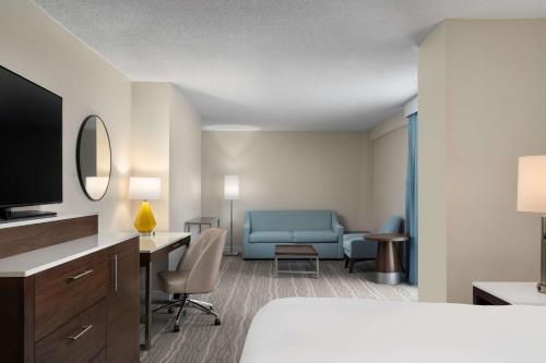a hotel room with a bed and a desk at DoubleTree by Hilton Norfolk Airport in Norfolk