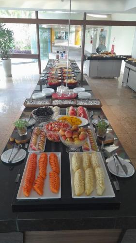 a buffet line with many different types of food at Flat Marulhos Resort Porto de Galinhas in Porto De Galinhas