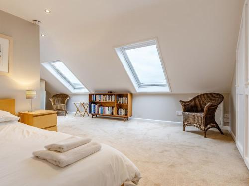 a bedroom with skylights and a bed and a book shelf at 4 Bed in Bere Alston RTIDE in Tamerton Foliot