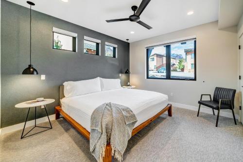 a bedroom with a bed and a chair and a window at LaFave Luxury Rentals at Zion in Springdale