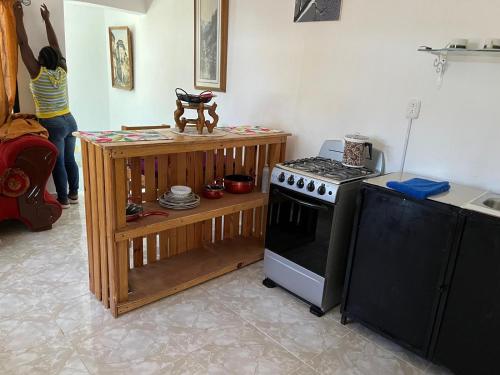 a kitchen with a stove and a counter with a table at Apartamento Carmen in Santa Cruz de Barahona