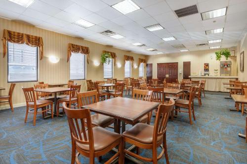 a dining room with wooden tables and chairs at Quality Inn Vienna - Tysons Corner in Tysons Corner