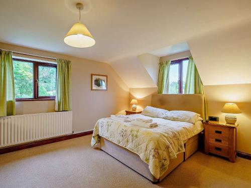 um quarto com uma cama e duas janelas em 5 Bed in Ennerdale SZ529 em Ennerdale Bridge
