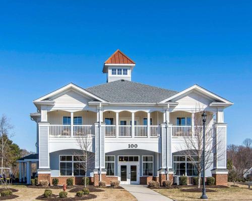 a large white building with a clock tower on top at Bluegreen Vacations Parkside Williamsburg, an Ascend Collection Resort in Williamsburg