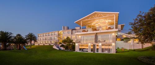 a large building with a lawn in front of it at Saldanha Bay Hotel in Saldanha