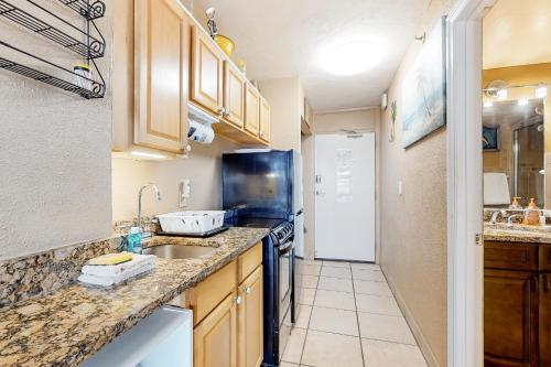 a kitchen with a sink and a counter top at Harbour Beach Resort Unit 808 in Daytona Beach