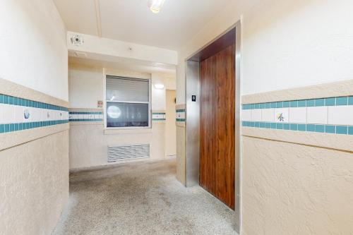 a hallway with a door and a television in a room at Harbour Beach Resort Unit 808 in Daytona Beach