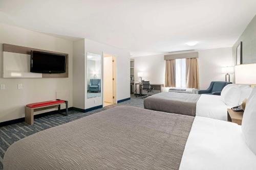 a hotel room with two beds and a flat screen tv at Quality Inn in Lebanon