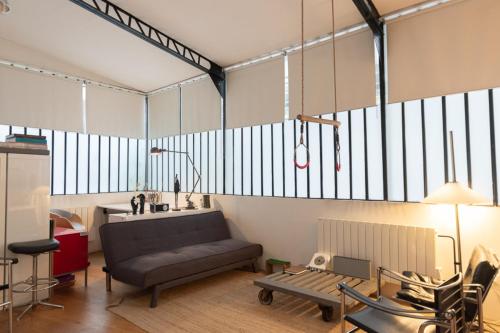 a living room with a couch and a table at Lovely loft in the heart of Paris in Paris