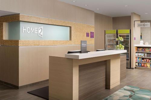 a store checkout counter in a store with a book shelf at Home2 Suites By Hilton Columbia Southeast Fort Jackson in Columbia