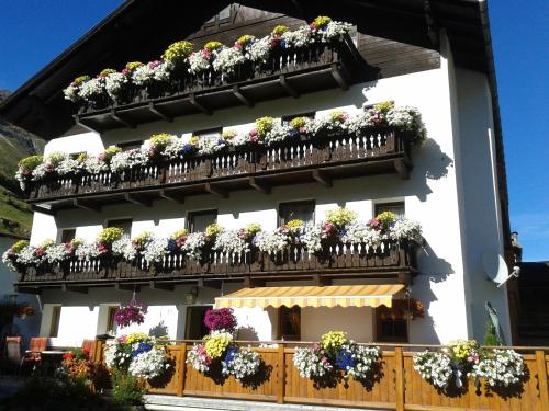 a building with lots of flower boxes on its balconies at Pension Elisabeth in Vent