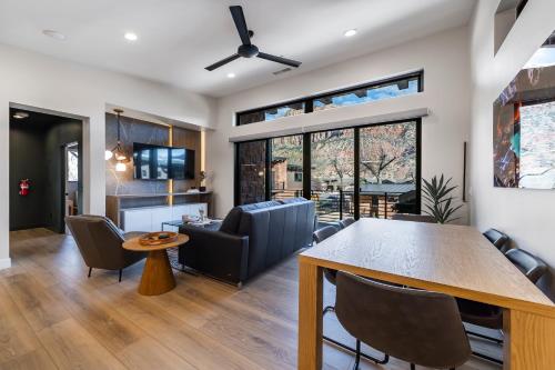 a dining room and living room with a table and chairs at LaFave Luxury Rentals at Zion in Springdale