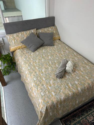 a bed with two pairs of shoes on it at Camine Home in Aradeo